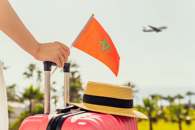 Traveller with Moroccan flag and suitcase
